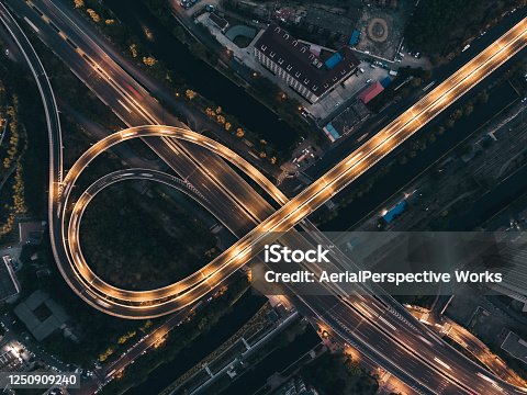 istock Top View of Overpass and City Traffic at Night 1250909240