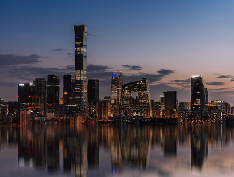 Singapore City, Singapore - 2nd December 2022: Dawn breaking over the central business district and Marina Bay in Singapore with Singapore cricket club in the foreground