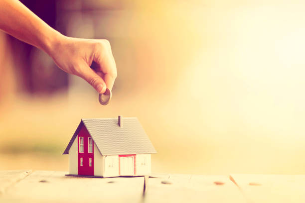 istock Real Estate Agent with house model and saving concepts 1250910240