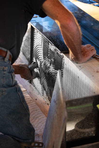 istock Tile Installation of granite on hearth of fireplace 1250911035