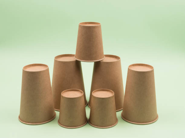 istock Group of paper cups on a green background. 1250914798