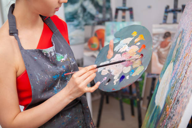 istock Young female artist painting at her workshop 1250914834