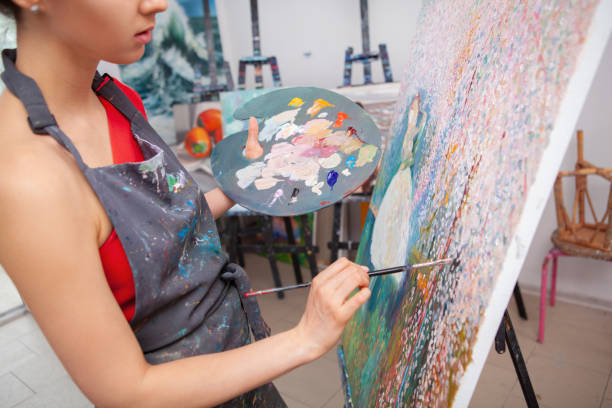 istock Young female artist painting at her workshop 1250914839