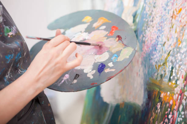 istock Young female artist painting at her workshop 1250914845