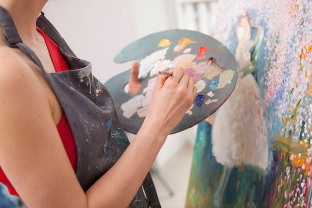 istock Young female artist painting at her workshop 1250914854