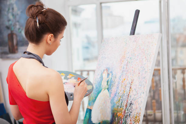 istock Young female artist painting at her workshop 1250914856
