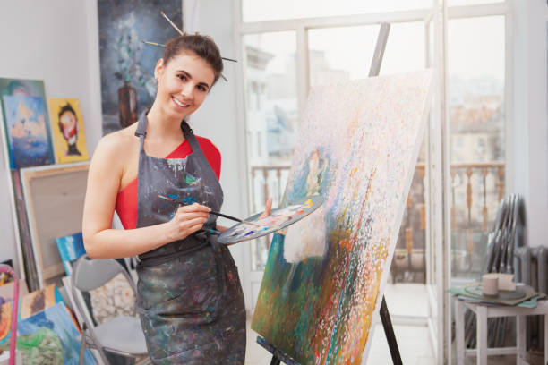 istock Young female artist painting at her workshop 1250914865