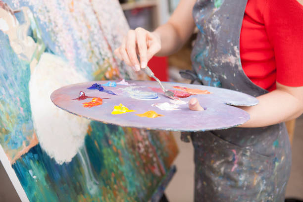 istock Young female artist painting at her workshop 1250914890