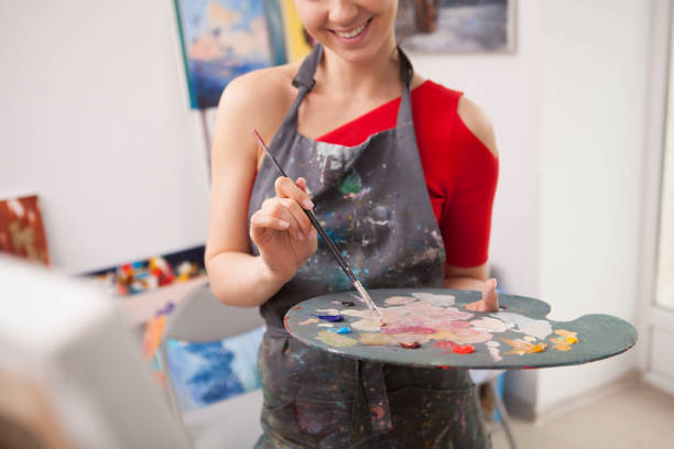 istock Young female artist painting at her workshop 1250914896