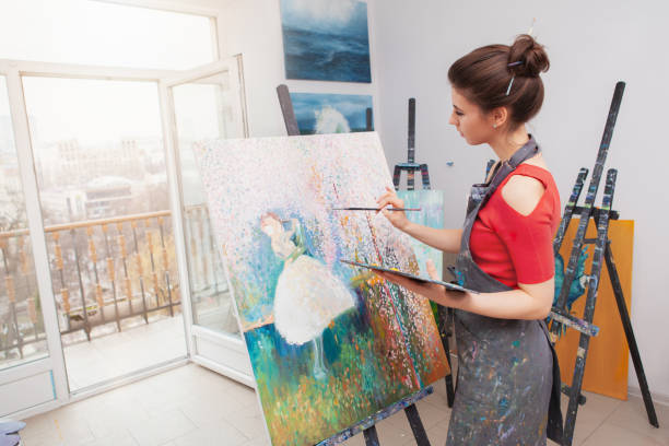 istock Young female artist painting at her workshop 1250914902