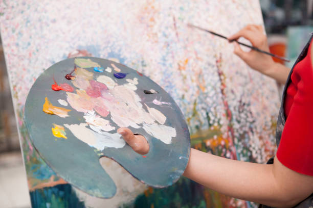 istock Young female artist painting at her workshop 1250914905