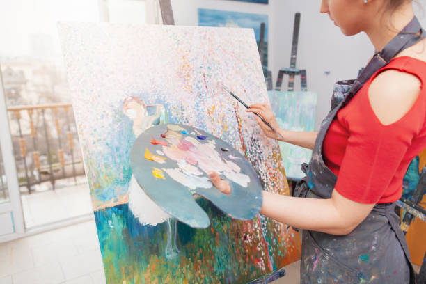 istock Young female artist painting at her workshop 1250914925