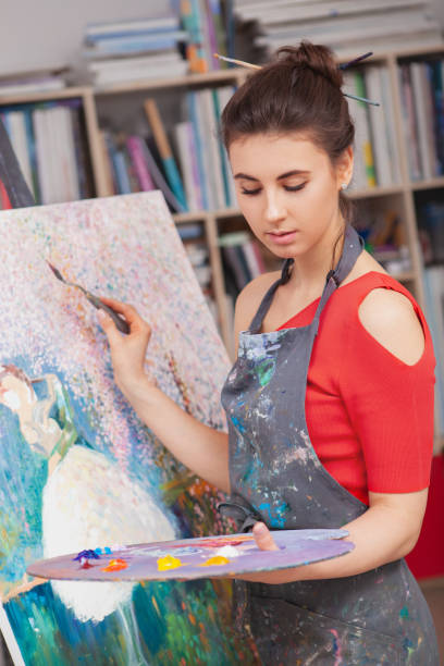 istock Young female artist painting at her workshop 1250915203