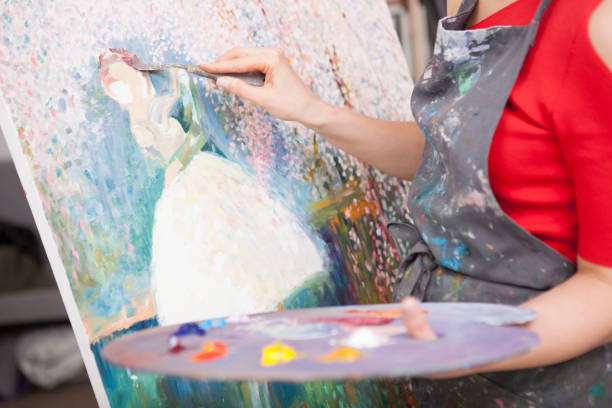 istock Young female artist painting at her workshop 1250915466