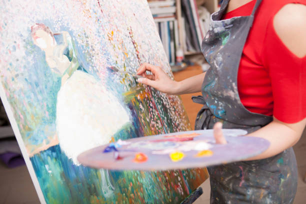 istock Young female artist painting at her workshop 1250915499