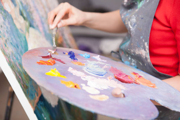 istock Young female artist painting at her workshop 1250915500