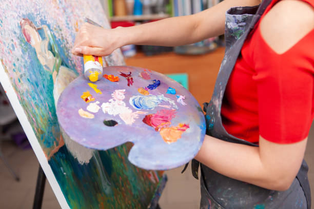 istock Young female artist painting at her workshop 1250915502