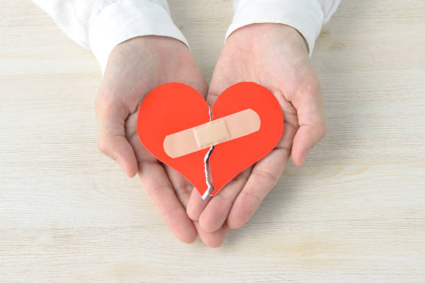 Broken heart with adhesive plaster Broken heart with adhesive plaster constituency photos stock pictures, royalty-free photos & images
