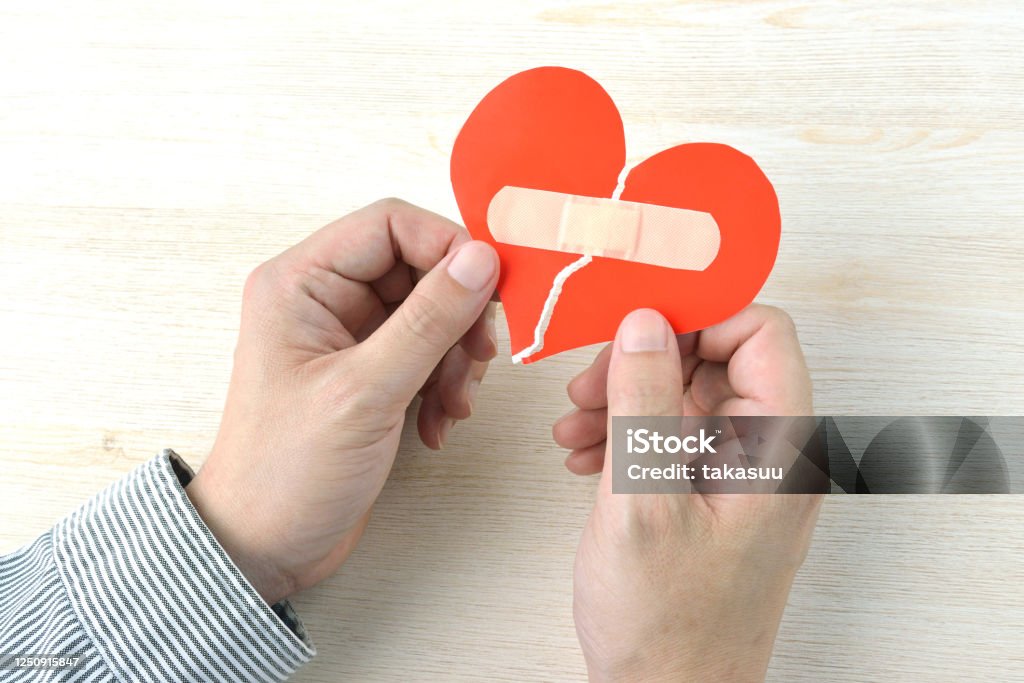 Broken heart with adhesive plaster Advice Stock Photo