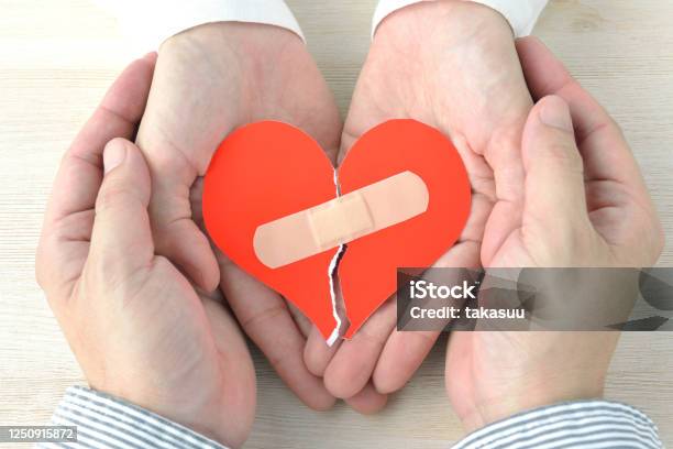 Couples Hands Having Broken Heart With Adhesive Plaster Stock Photo - Download Image Now