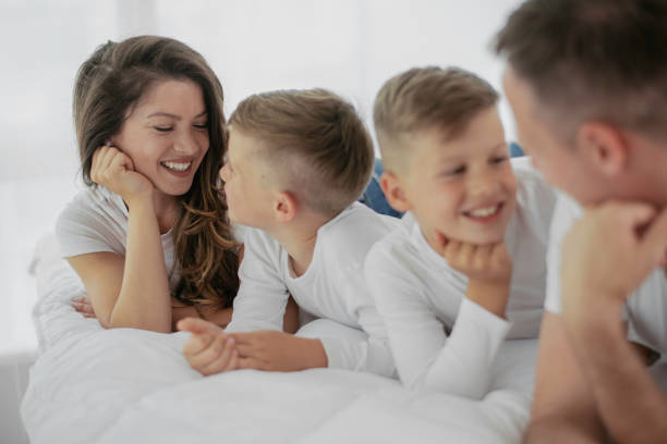 istock Happy parents with sons relaxing in bed. 1250917609