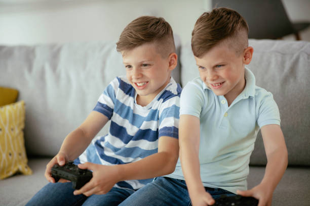 istock Young brothers having fun while playing video games in living room 1250917768