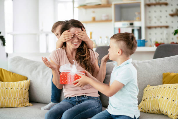 istock Two young sons are giving their mother a gift. 1250917807