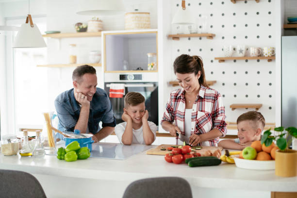 Young happy family making sandwich at home Young happy family making sandwich at home. Mom and dad preparing breakfast with sons. breakfast room photos stock pictures, royalty-free photos & images