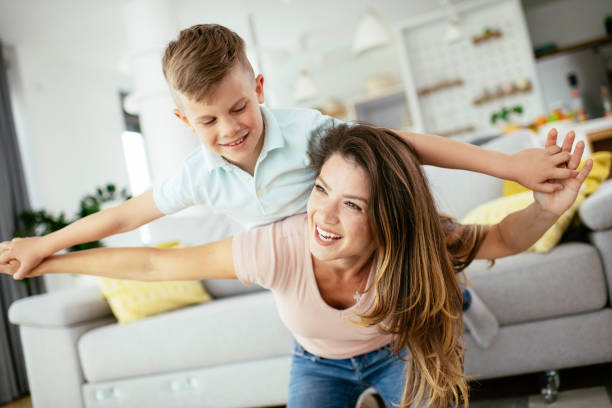 istock Mother and son playing in living room. 1250918697