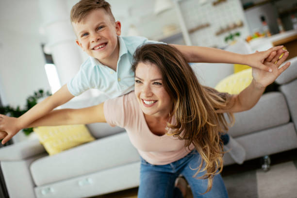 istock Mother and son playing in living room. 1250918704