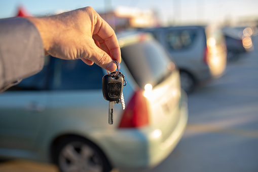 car salesperson holding car key selective focus