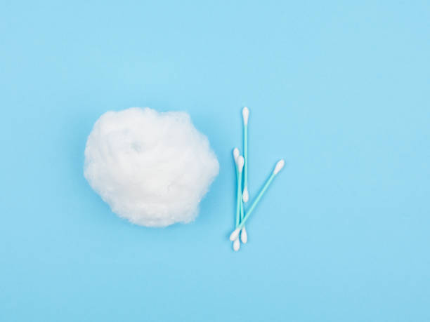istock Cotton wool and ear sticks on a blue background. 1250919063