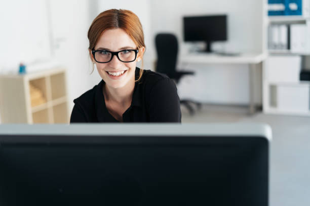 istock Attractive businesswoman working at a computer 1250919849