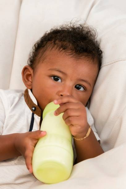 istock Stand-alone baby. Feeding infant with milk. 1250921033
