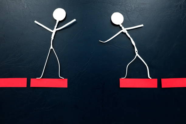 Motivation and courage concept. Human stick figures crossing a broken red bridge.Motivation and courage concept. Human stick figures crossing a broken red bridge.