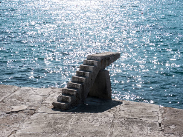 Stone stairway on concrete sea breakwater side view
