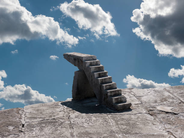 Old lonely stone stairway on concrete base side view above cloudy sky