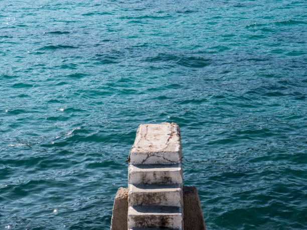 istock Stone stairway on concrete sea breakwater top view 1250921895