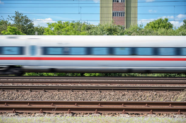 istock Passing express train against blue sky and an old building 1250922814