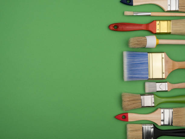 istock Set of different brushes for painting on a green background. 1250924371