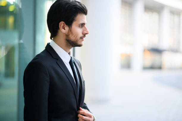 istock Young businessman outdoor in a serious expression adjusting his look 1250924528