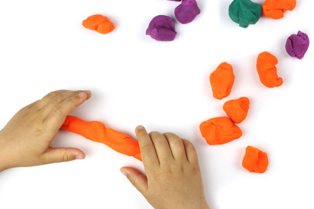 istock A child plays with colored modeling clay, plasticine on a white background 1250925451