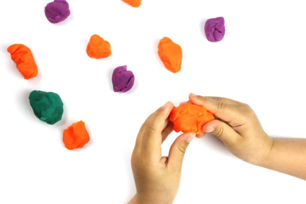 istock A child plays with colored modeling clay, plasticine on a white background 1250925465