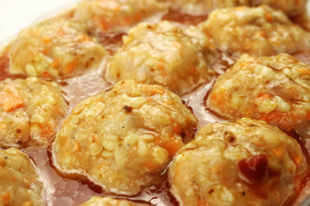 istock Raw meatballs in gravy in a baking container 1250925506