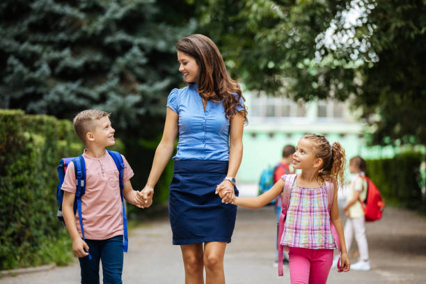 istock Mother taking her children to school 1250925520