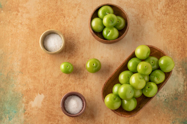 istock fresh ripe green plums on a table served with salt 1250926617