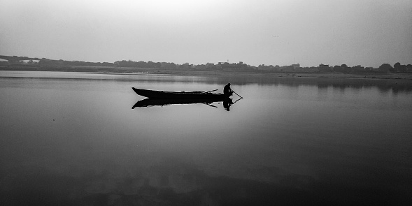 A fisherman is silently waiting far a fish