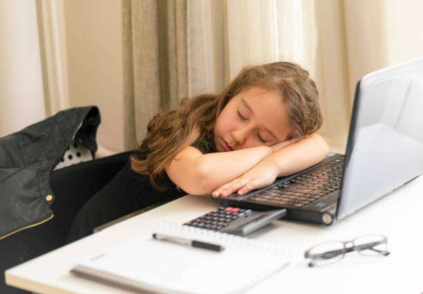 istock Little student girl with laptop pc at home 1250933123