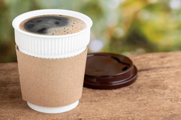 coffee cup or disposable cup on the wooden table background on natural morning with copy space for your text and logo. - starbucks take out food coffee disposable cup imagens e fotografias de stock