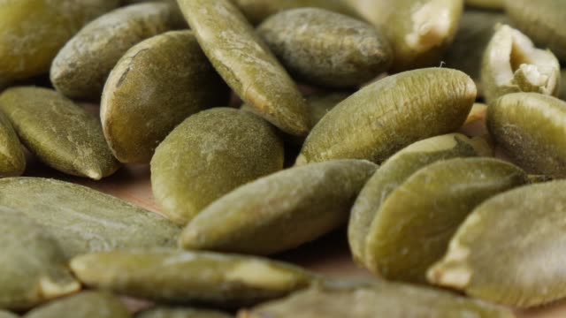 Closed up pumpkin seeds, slow motion.